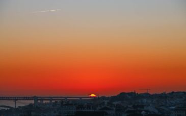 Red-orange sunset over a city in Portugal